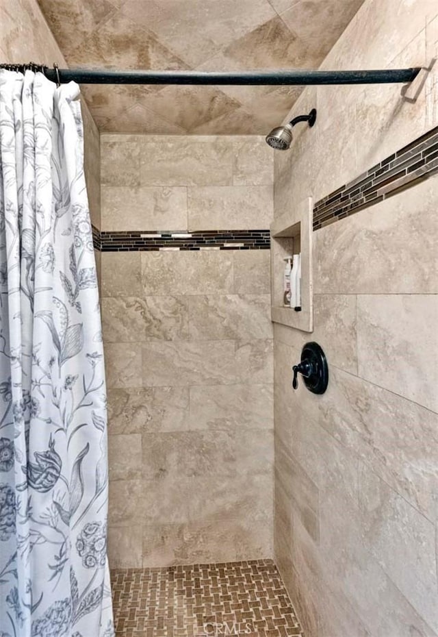 full bathroom with tiled shower