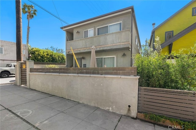 exterior space featuring a fenced front yard and stucco siding