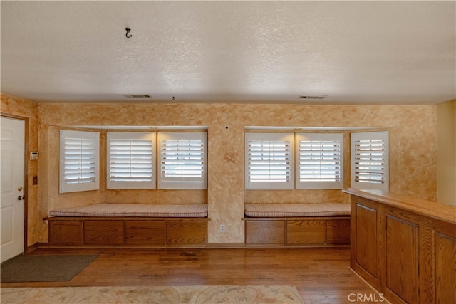 entrance foyer with a textured ceiling and light wood-style flooring