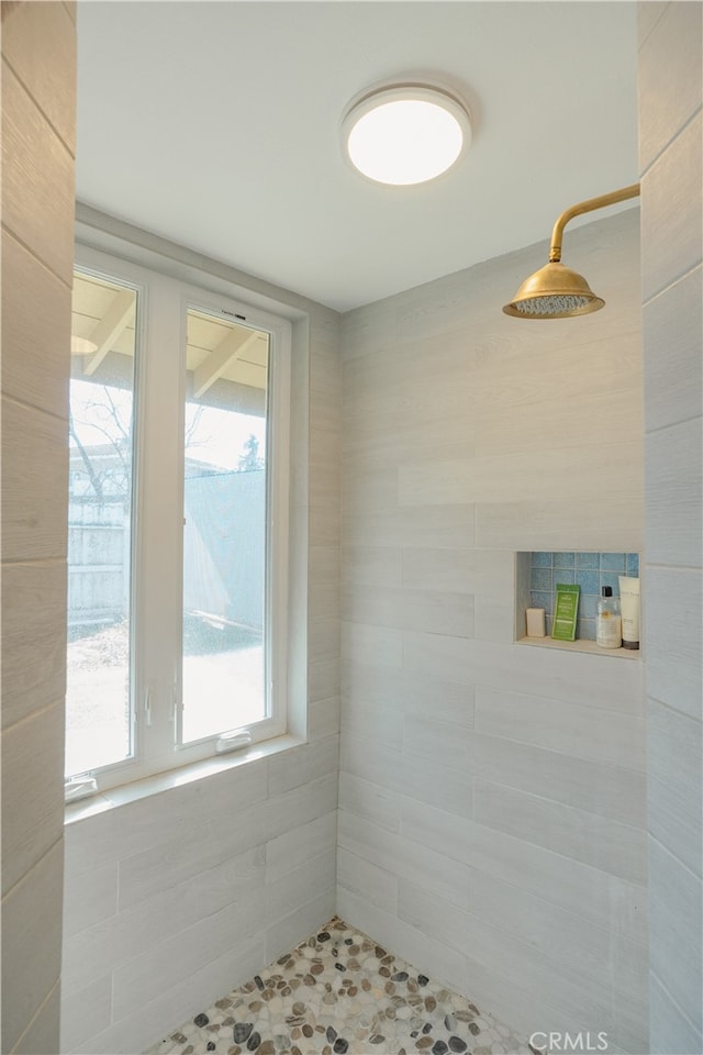 bathroom with a tile shower