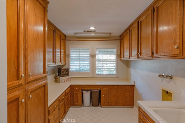 kitchen with visible vents, brown cabinets, and light countertops