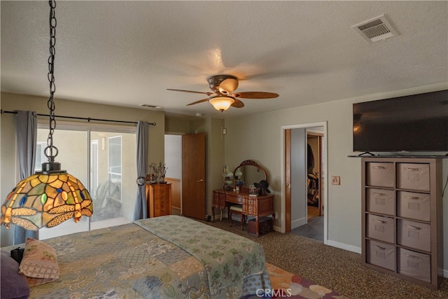 carpeted bedroom featuring baseboards, visible vents, a textured ceiling, and a ceiling fan