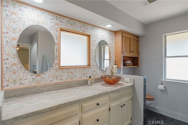 bathroom with visible vents, toilet, wallpapered walls, tile patterned flooring, and vanity