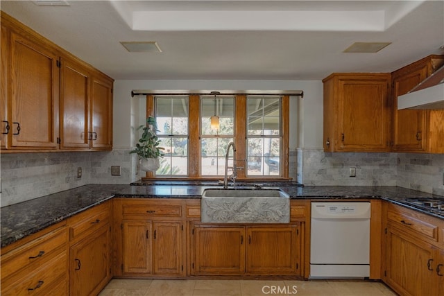 kitchen with dishwasher, brown cabinets, and a sink