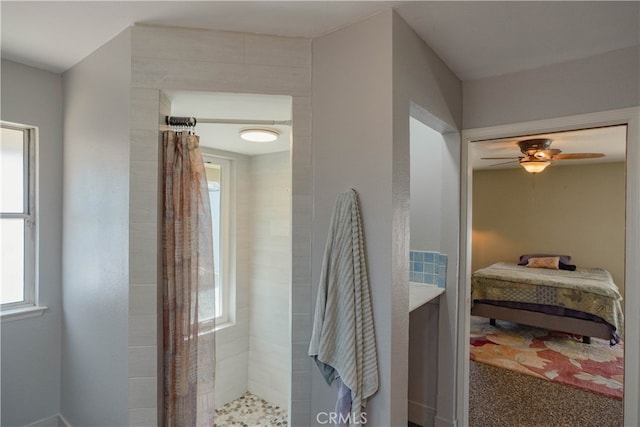 bathroom with ensuite bathroom, a ceiling fan, a wealth of natural light, and tiled shower