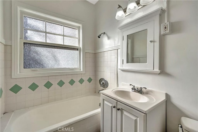 full bathroom with a bath, a shower, toilet, and vanity