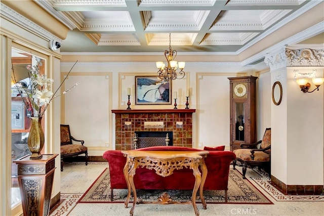 sitting room featuring beamed ceiling, a notable chandelier, ornamental molding, coffered ceiling, and a fireplace