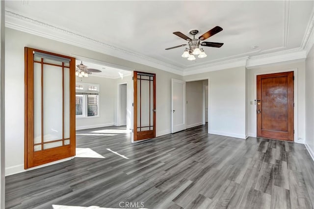 interior space with baseboards, a ceiling fan, ornamental molding, and dark wood-style flooring