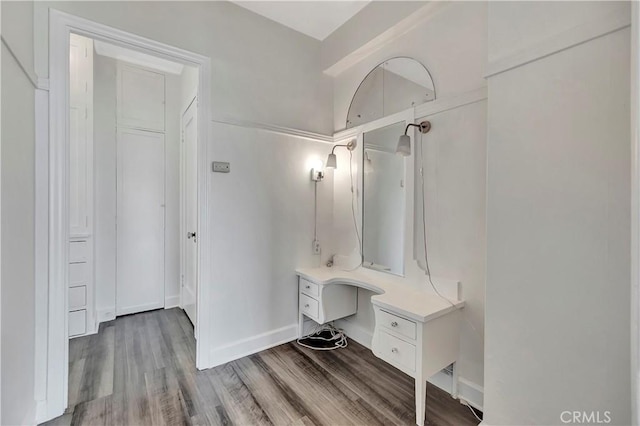 interior space with baseboards, wood finished floors, and vanity