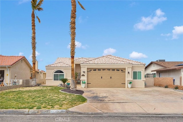 view of front of home featuring fence, driveway, an attached garage, stucco siding, and a front lawn