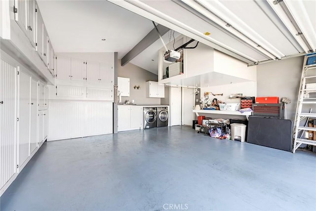 garage featuring washing machine and clothes dryer and a garage door opener