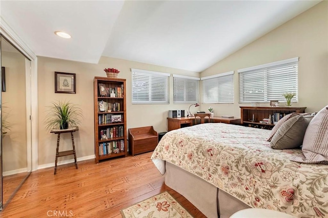 bedroom featuring recessed lighting, a closet, light wood finished floors, baseboards, and vaulted ceiling