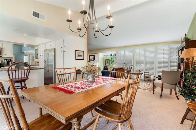 dining area featuring light carpet, visible vents, and a notable chandelier