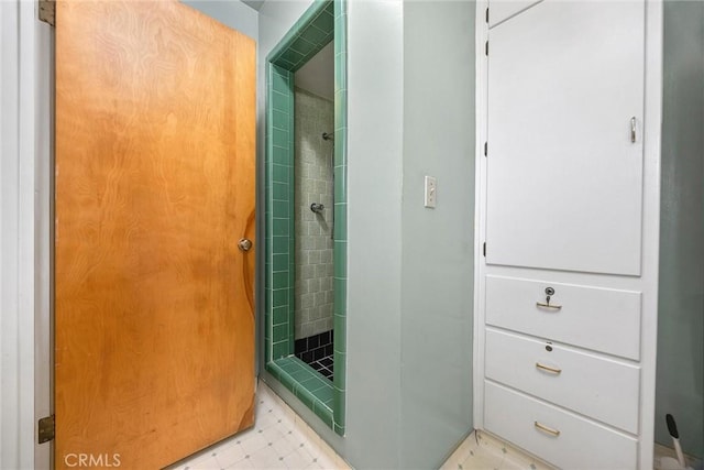 bathroom featuring tile patterned floors and a stall shower