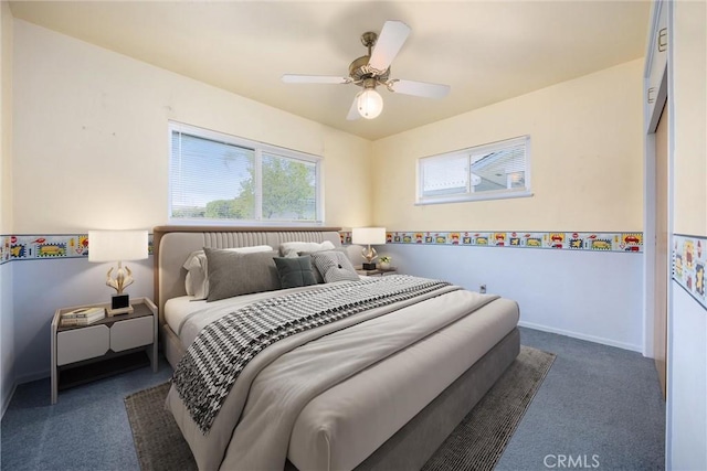 carpeted bedroom with a ceiling fan and baseboards