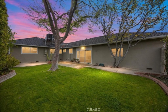 rear view of property featuring crawl space, a yard, cooling unit, and stucco siding