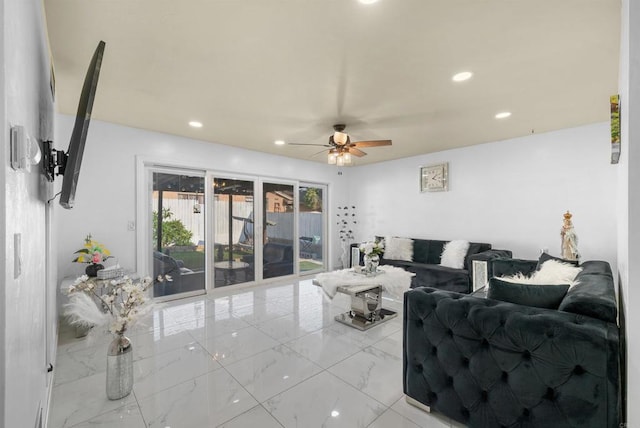 living area featuring a ceiling fan, recessed lighting, and marble finish floor