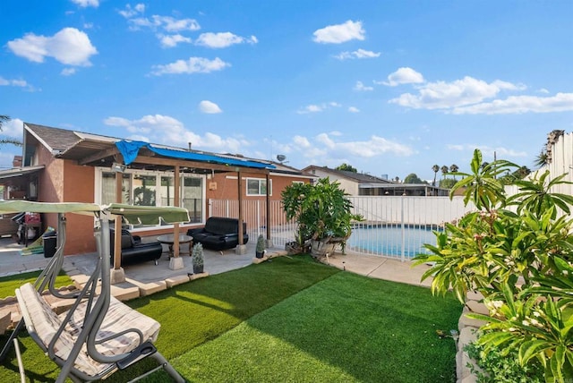 back of property featuring a patio area, a fenced in pool, fence, and a lawn