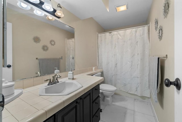 bathroom with vanity, toilet, and marble finish floor