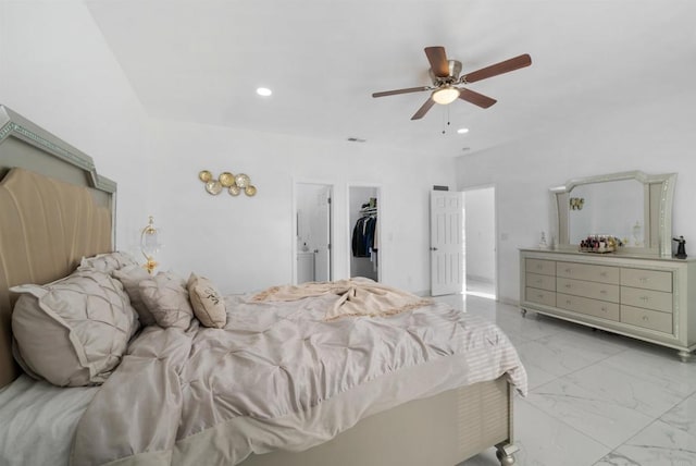 bedroom with visible vents, a walk in closet, recessed lighting, marble finish floor, and a ceiling fan