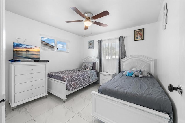 bedroom with marble finish floor and a ceiling fan