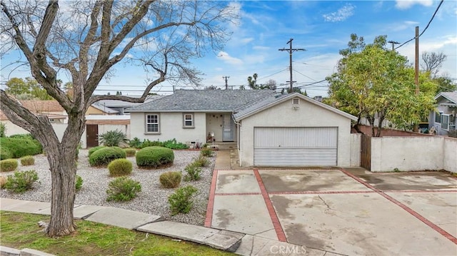 single story home featuring stucco siding, a garage, and fence