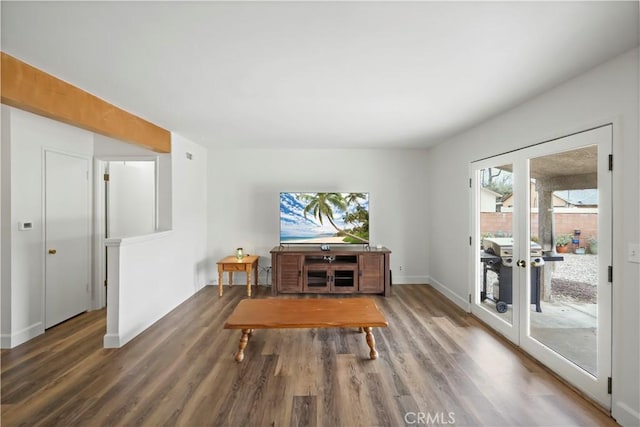 interior space featuring wood finished floors, baseboards, and french doors