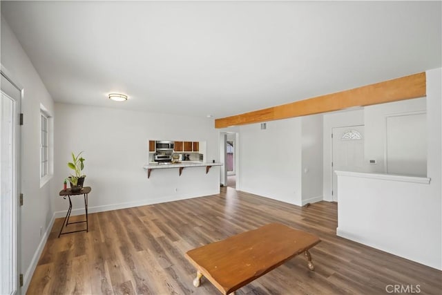 living room featuring baseboards and wood finished floors