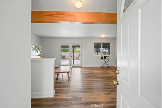 foyer entrance with french doors, baseboards, beamed ceiling, and wood finished floors