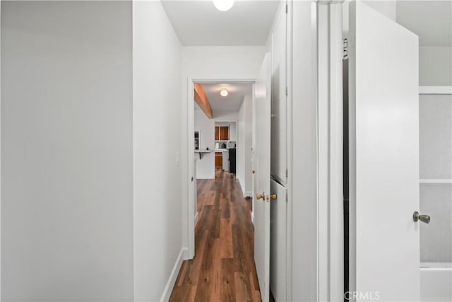 hallway with baseboards and dark wood finished floors