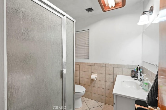 bathroom with vanity, visible vents, a stall shower, tile patterned floors, and toilet