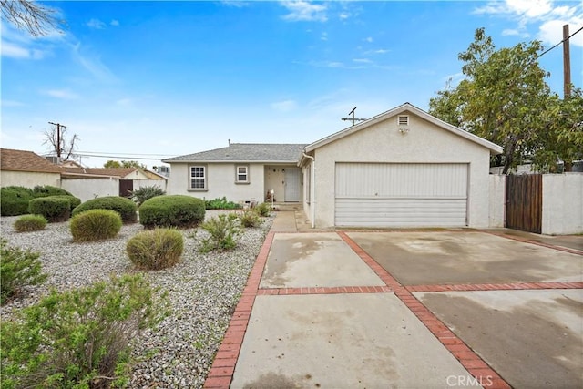 ranch-style house featuring stucco siding, concrete driveway, a garage, and fence