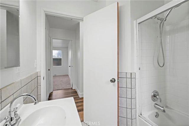 bathroom featuring wood finished floors, shower / tub combination, and a sink