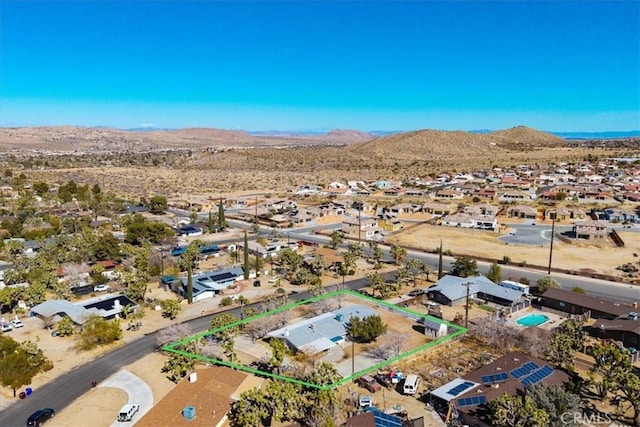 bird's eye view with a desert view and a mountain view