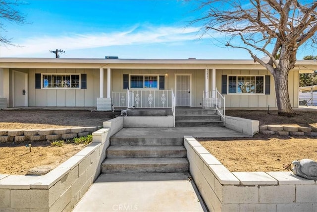 ranch-style home with covered porch and board and batten siding