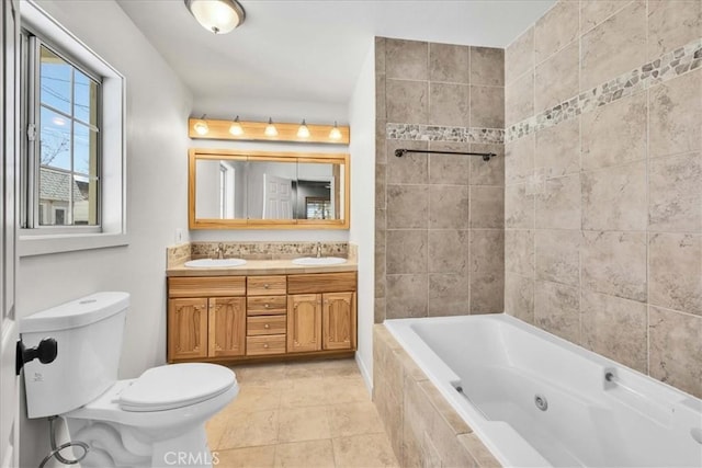 bathroom featuring a sink, toilet, double vanity, and a whirlpool tub