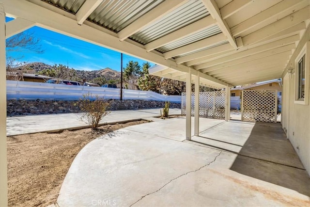 view of patio / terrace featuring a mountain view and a fenced backyard