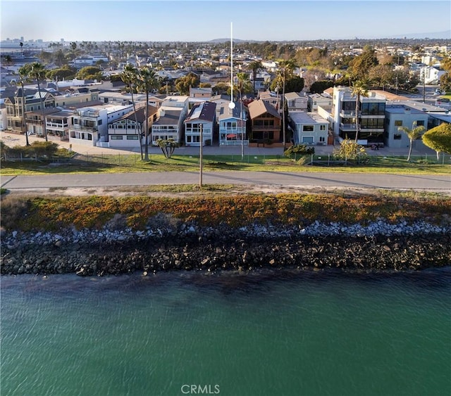 drone / aerial view with a residential view and a water view