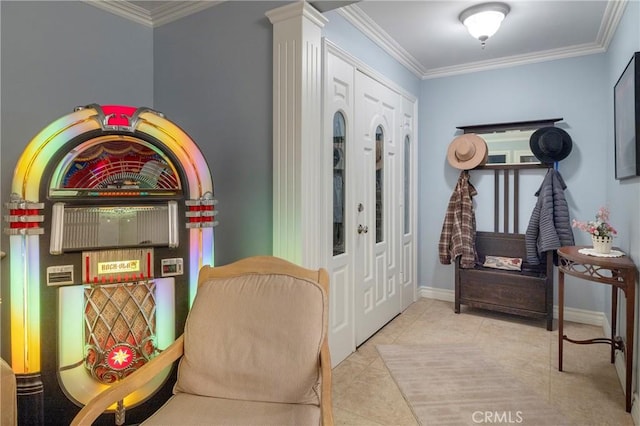 foyer entrance with tile patterned floors, decorative columns, baseboards, and ornamental molding