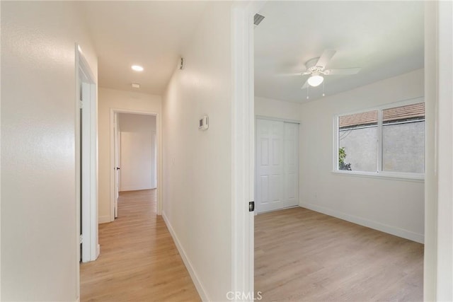 hall featuring recessed lighting, visible vents, baseboards, and light wood-type flooring