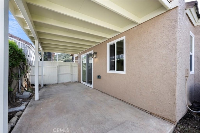 view of patio featuring fence