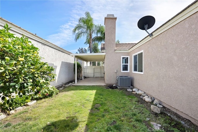 view of yard featuring cooling unit, a patio area, and fence