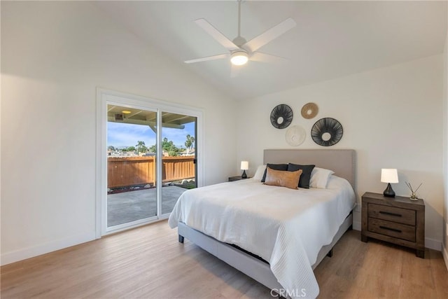 bedroom with baseboards, lofted ceiling, light wood-style floors, and access to outside