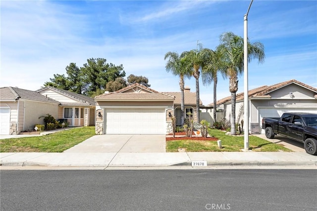 ranch-style house featuring a garage, concrete driveway, a front yard, and a tile roof