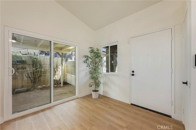 entryway featuring lofted ceiling and light wood-style floors