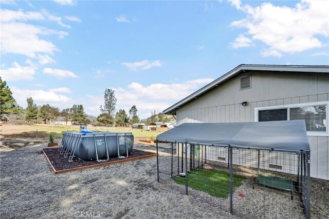 view of yard featuring a covered pool