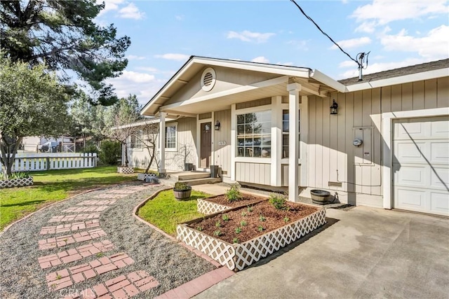 ranch-style house with a front lawn, an attached garage, and fence