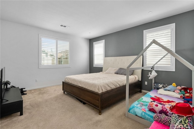 carpeted bedroom with visible vents and baseboards