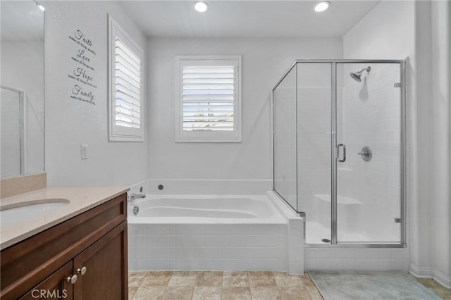 bathroom with recessed lighting, a stall shower, vanity, and a garden tub