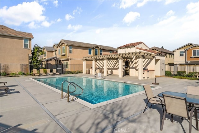 community pool with a residential view, a pergola, a patio, and fence